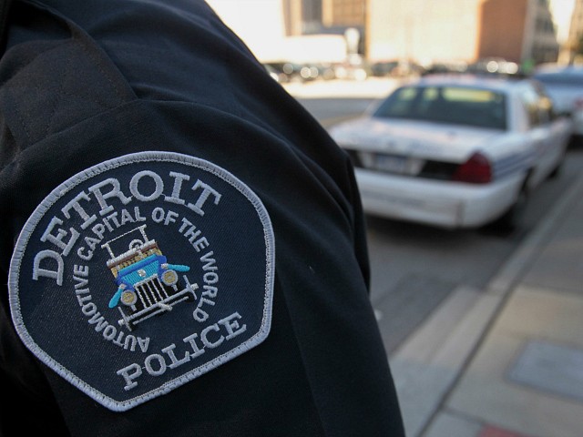 The emblem for the Detroit Police Department is seen on the sleeve of an officer outside of the Theodore Levin U.S. Courthouse in Detroit, Michigan, U.S., on Wednesday, July 24, 2013. Detroit began its first court hearing after filing the biggest U.S. municipal bankruptcy. The city plans to seek a court order barring lawsuits against Michigan Governor Rick Snyder that are related to the case. Photographer: Jeff Kowalsky/Bloomberg via Getty Images