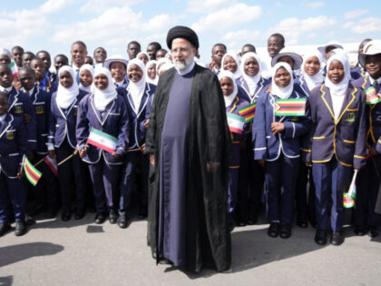 Iran's President Ebrahim Raisi poses for a photograph with children upon his arrival at Robert Mugabe airport in Harare, Zimbabwe, Thursday, July 13, 2023. Iran's president is on a rare visit to Africa as the country, which is under heavy U.S. economic sanctions, seeks to deepen partnerships around the world. …