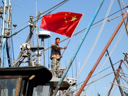 Fishermen hang brand new five-star red flags on their fishing boats in Lianyungang, Jiangsu province, China, Sept 26, 2022. (Photo credit should read CFOTO/Future Publishing via Getty Images)