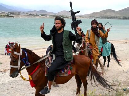 TOPSHOT - Taliban security forces ride horses along the Qargha Lake on the outskirts of Kabul on May 11, 2023. (Photo by Wakil Kohsar / AFP) (Photo by WAKIL KOHSAR/AFP via Getty Images)