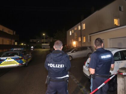 29 July 2023, Bavaria, Langweid: Police officers stand in front of a house where three people were shot. In an apartment building in a small village near Augsburg, a man shot three people: two women and a man, according to police. Two other people he had seriously injured on Friday …