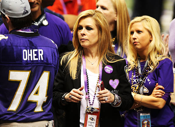Leigh Anne Tuohy celebrates on the field after her adoptive son Michael Oher of the Baltimore Ravens and the Ravens defeat the San Francisco 49ers...