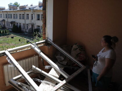 LVIV, UKRAINE - AUGUST 15: Woman stand near broken window after missile fragment hit an apartment residential building on August 15, 2023 in Lviv, Ukraine. Russia attacked the city of Lviv and oblast in the west of Ukraine with missiles. The Ukrainian Air Defense Forces shot down part of the …