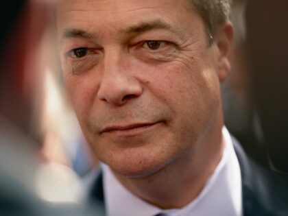 AYLESBURY, UNITED KINGDOM - APRIL 30: UK Independence Party (UKIP) leader Nigel Farage talks with journalists while campaigning in Market Square on April 30, 2015 in Aylesbury, England. A natural campaigner, Farage has a confidence and charisma that invites a crush of party supporters, journalists and curious onlookers whenever he …