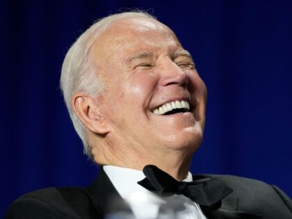 President Joe Biden laughs as comedian Roy Wood Jr., a correspondent for "The Daily Show," speaks during the White House Correspondents' Association dinner at the Washington Hilton in Washington, Saturday, April 29, 2023. (AP Photo/Carolyn Kaster)