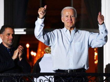 President Joe Biden gives two thumbs up from a balcony of the White House as his son Hunter Biden (L) looks on during 4th of July fireworks in Washington, DC, July 4, 2022. (NICHOLAS KAMM/AFP via Getty Images)