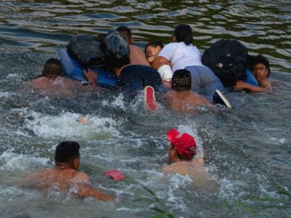 MATAMOROS, MEXICO - May 11: Migrants traverse the Rio Grande River in order to cross the United States border as Title 42 expires on May 11, 2023 in Matamoros, Mexico. Title 42 is a Trump-era policy that allows border agents to quickly turn away migrants seeking asylum due to COVID-related …