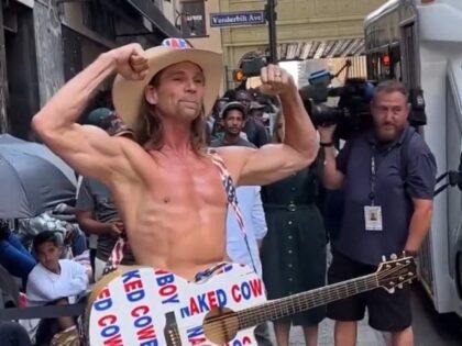 New York City's "Naked Cowboy" performs near migrant shelter. (Saul Acevedo, Used with Permission)