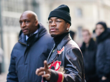 PARIS, FRANCE - JANUARY 20: Singer Ne-Yo wears a black wool beanie hat, earrings, glasses, a necklace, a black turtleneck pullover, a black and red leather jacket with printed patterns, outside Viktor & Rolf, during Paris Fashion Week - Haute Couture Spring/Summer 2020, on January 20, 2020 in Paris, France. …