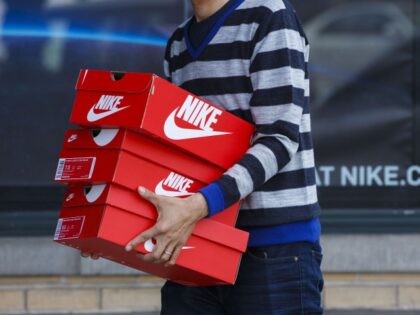 A customer carries boxes of Nike Inc. shoes outside of the NikeTown Los Angeles retail store in Beverly Hills, California, U.S., on Sunday, March 20, 2016. Nike is scheduled to release earnings figures on March 22. Photographer: Patrick T. Fallon/Bloomberg via Getty Images