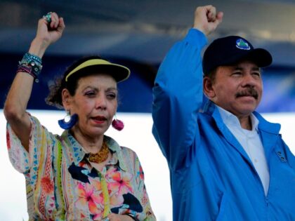Nicaraguan President Daniel Ortega and his wife, Vice-President Rosario Murillo, raise their fists during the commemoration of the 51st anniversary of the Pancasan guerrilla campaign in Managua, on August 29, 2018. - Ortega called the UN High Commissioner for Human Rights "infamous" and "terror instrument", after it denounced Wednesday systematic …