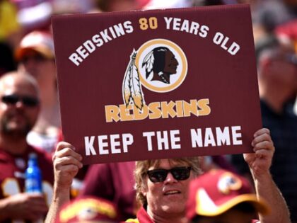 LANDOVER, MD - SEPTEMBER 14: A Washington Redskins fan holds up a sign to keep the Redskins name before they play the Jacksonville Jaguars at FedExField on September 14, 2014 in Landover, Maryland. The Washington Redskins won, 41-10. (Photo by Patrick Smith/Getty Images)
