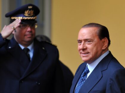 Italian Prime Minister Silvio Berlusconi walks during a meeting with Vietnamese President Nguyen Minh Triet (not pictured) in Milan on 12 December, 2009. Triet is on a European tour that includes Italy, Spain and Slovakia. AFP PHOTO / GIUSEPPE CACACE (Photo credit should read GIUSEPPE CACACE/AFP via Getty Images)