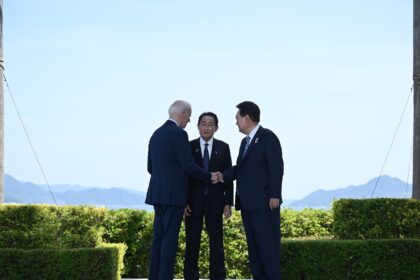 US President Joe Biden, Japanese Prime Minister Fumio Kishida, and South Korean President Yoon Suk Yeol greet one another during the G7 Leaders' Summit in Hiroshima on May 21, 2023