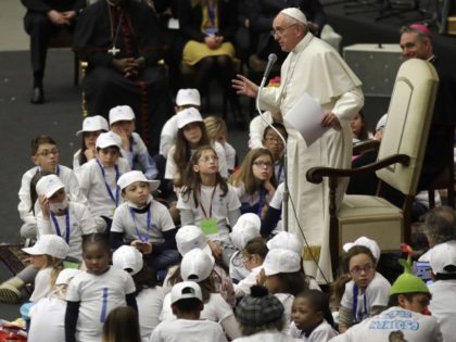 FILE - In this Thursday, Dec. 15, 2016 file photo, Pope Francis is surrounded by children as he speaks with patients and caregivers from the Vatican's Bambino Gesu Pediatric Hospital. During the audience in the Vatican's Paul VI hall, Francis exhorted hospital staff not to fall prey to corruption, which …