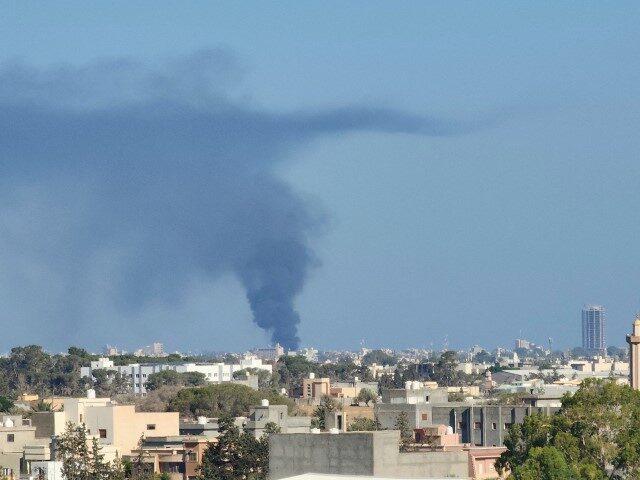 Smoke billows amid clashes between armed groups affiliated with Libya's Tripoli-based Government of National Unity (GNU) in the Libyan capital on August 15, 2023. (MAHMUD TURKIA/AFP via Getty Images)