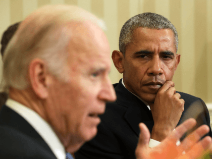 U.S. Vice President Joseph Biden (L) speaks as President Barack Obama (R) listens during a meeting to release the Cancer Moonshot Report in the Oval Office of the White House October 17, 2016 in Washington, DC. Vice President Biden released the report, which focused on speeding up the development of …
