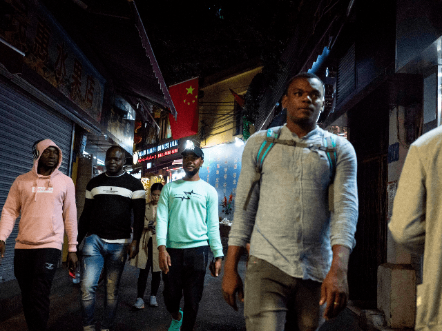 In this photo taken on March 1, 2018, people walk in the "Little Africa" district in Guangzhou, the capital of southern China's Guangdong province. - The commercial hub has long been a magnet for fortune-seeking Africans, but traders and students say they face unfavourable visa rules and increasingly heavy policing. (Photo by FRED DUFOUR / AFP) / TO GO WITH AFP STORY CHINA-AFRICA-TRADE-IMMIGRATION,FEATURE BY JOANNA CHIU (Photo credit should read FRED DUFOUR/AFP via Getty Images)